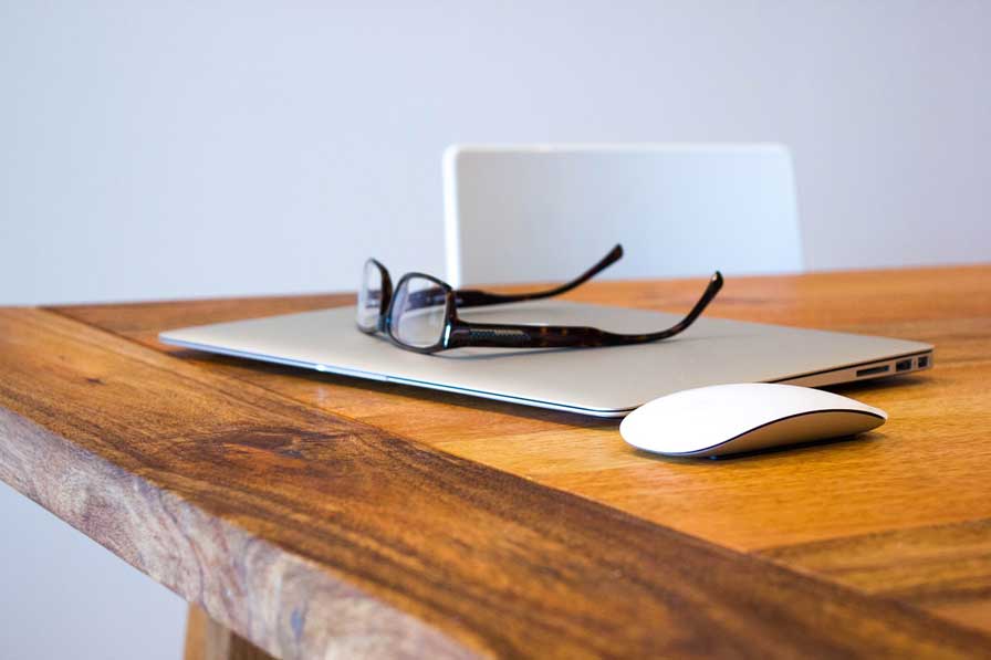 laptop and glasses on table