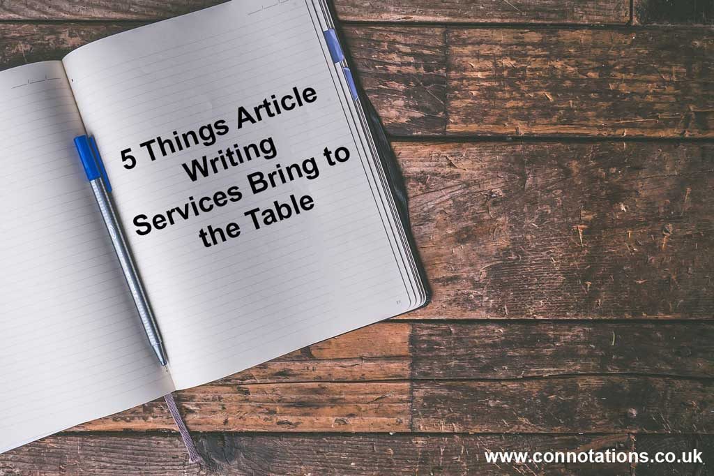 Table, exercise book and pen - 5 Things Article Writing Services Bring to the Table